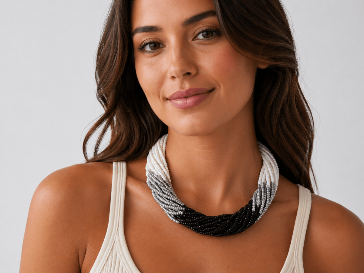 monochrome multi strand necklace being worn by a model in a white top Main image