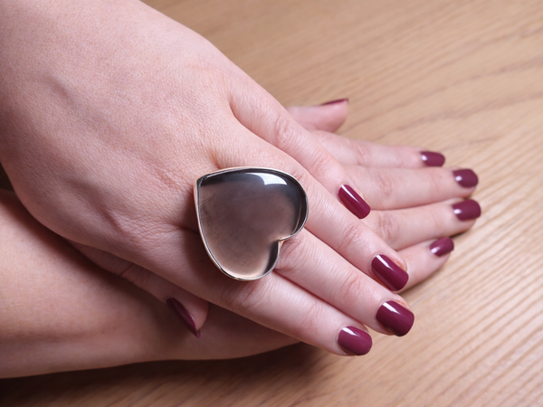 Woman wearing a large heart shaped smokey quartz ring