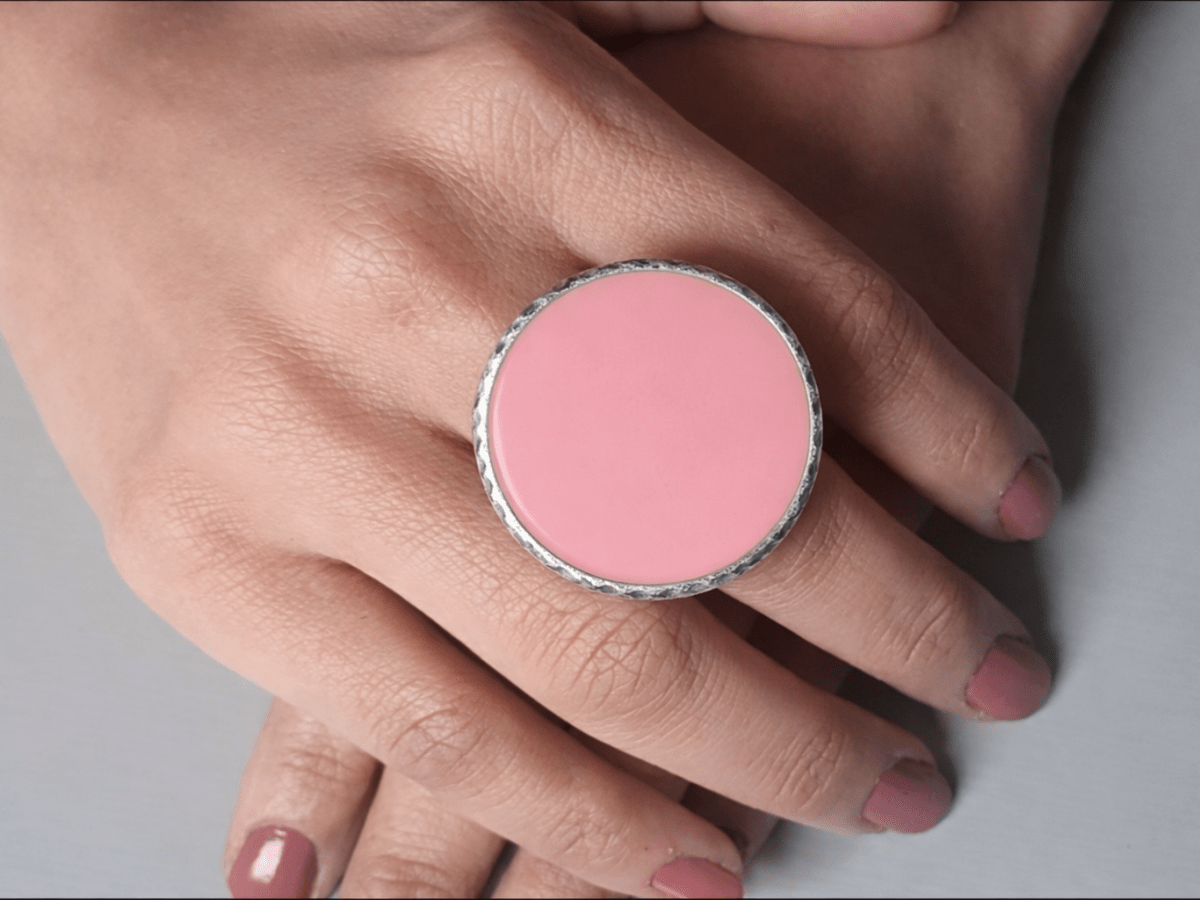A models hands wearing a large pink ring