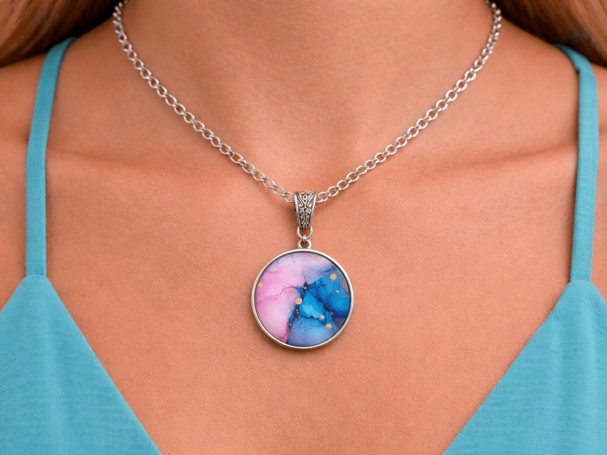 Sariyah pink and blue glass pendant being worn by a model - Corky & Stoner Main image