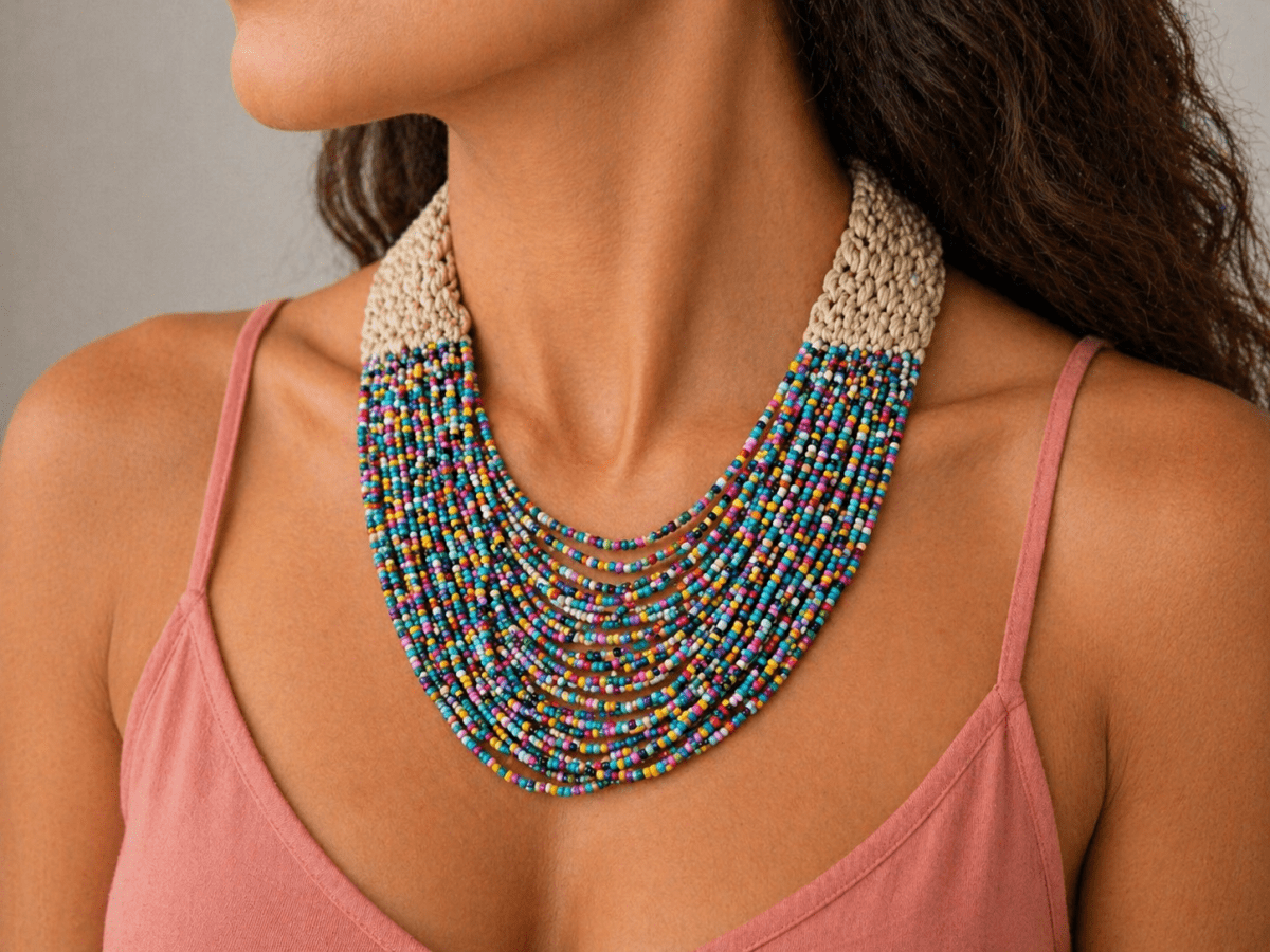 Multi coloured seed bead necklace being worn by a model in a pink top
