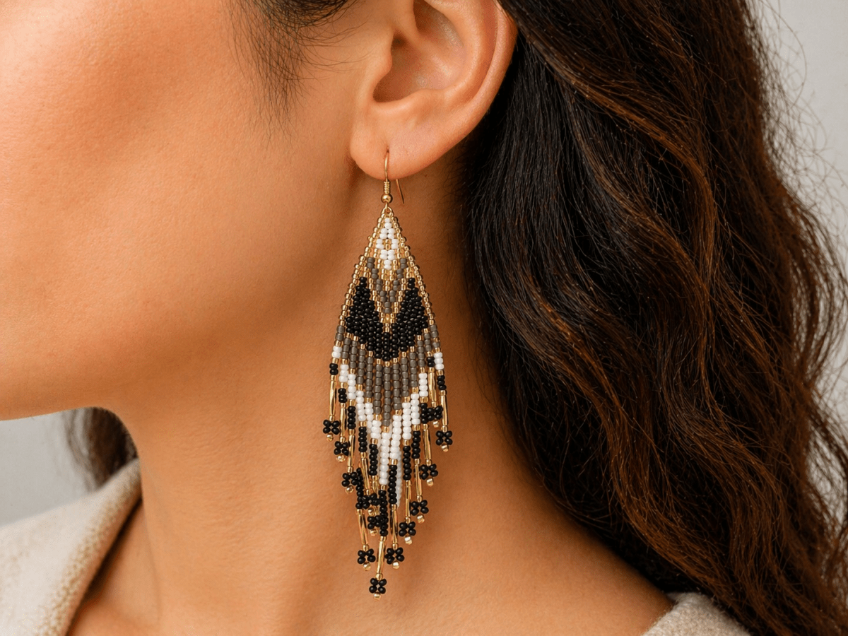 Noemi handmade brown and white seed bead fringe earrings being worn by a model - Corky & Stoner