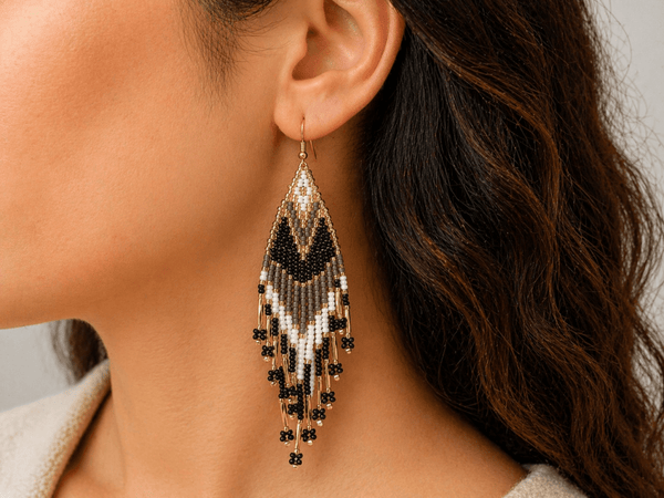 Noemi handmade brown and white seed bead fringe earrings being worn by a model - Corky & Stoner