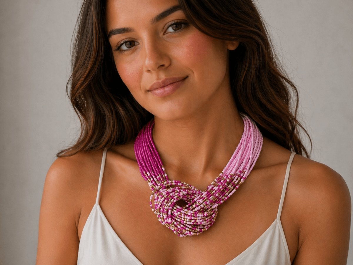  pink knotted seed bead necklace being worn by a model with a white top
