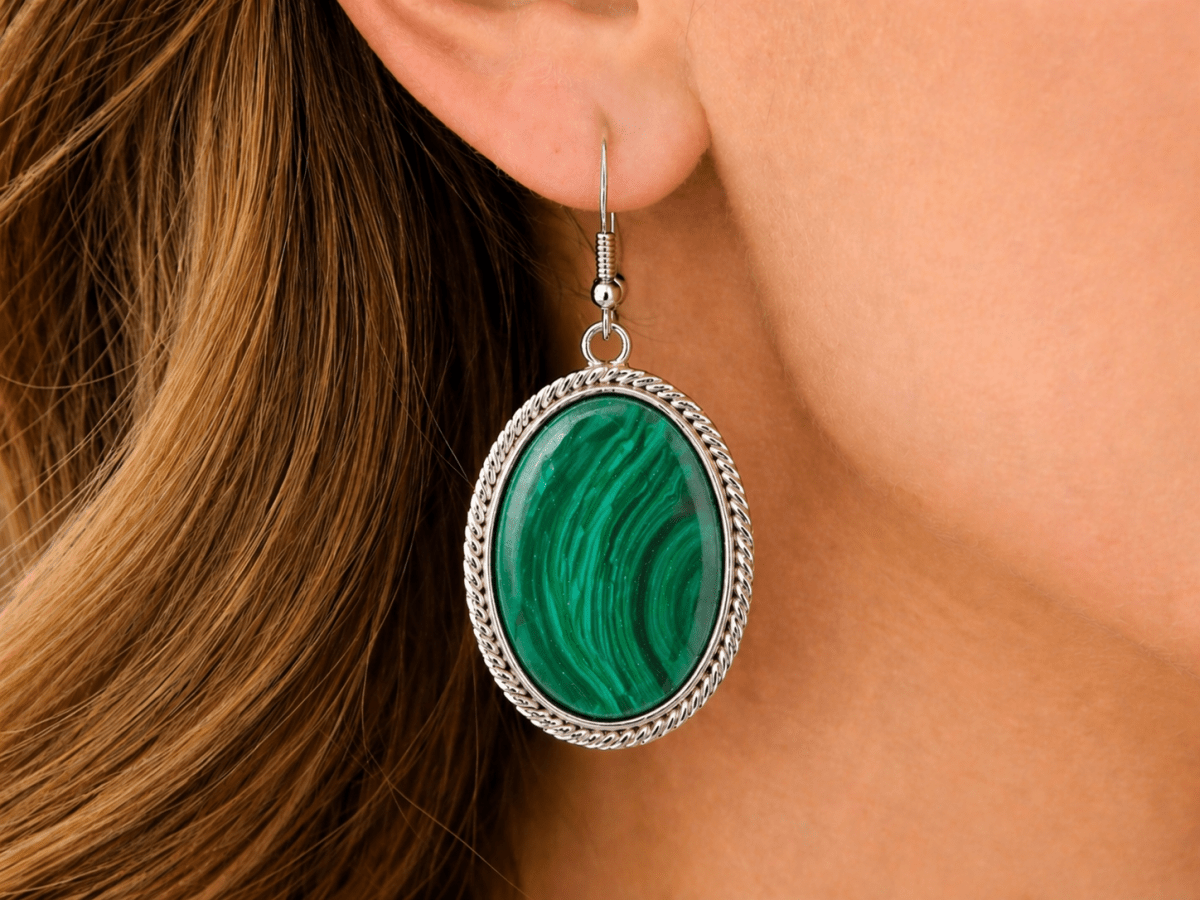 Striking, bold, and full of character. These oval drop earrings feature a faux malachite stone with rich green banding, set within a twisted silver-tone frame for a strong, polished finish. - Corky & Stoner