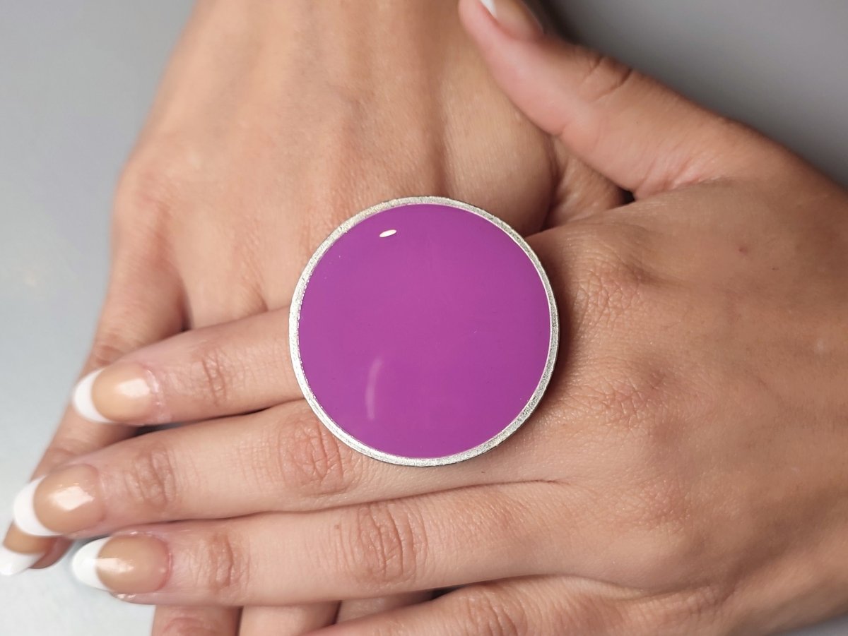A models hands wearing a violet ring