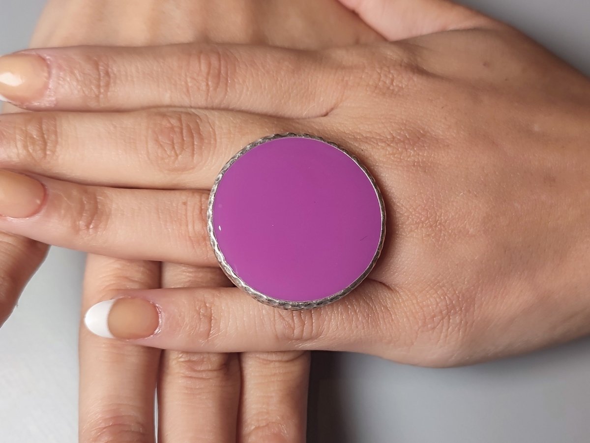 A models hands wearing a large violet ring