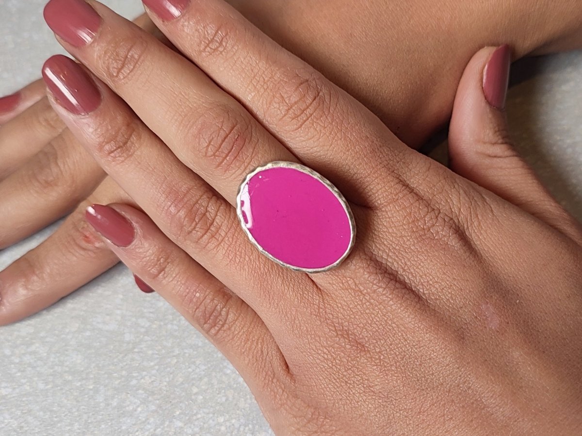 A models hands wearing a bright pink ring Main image