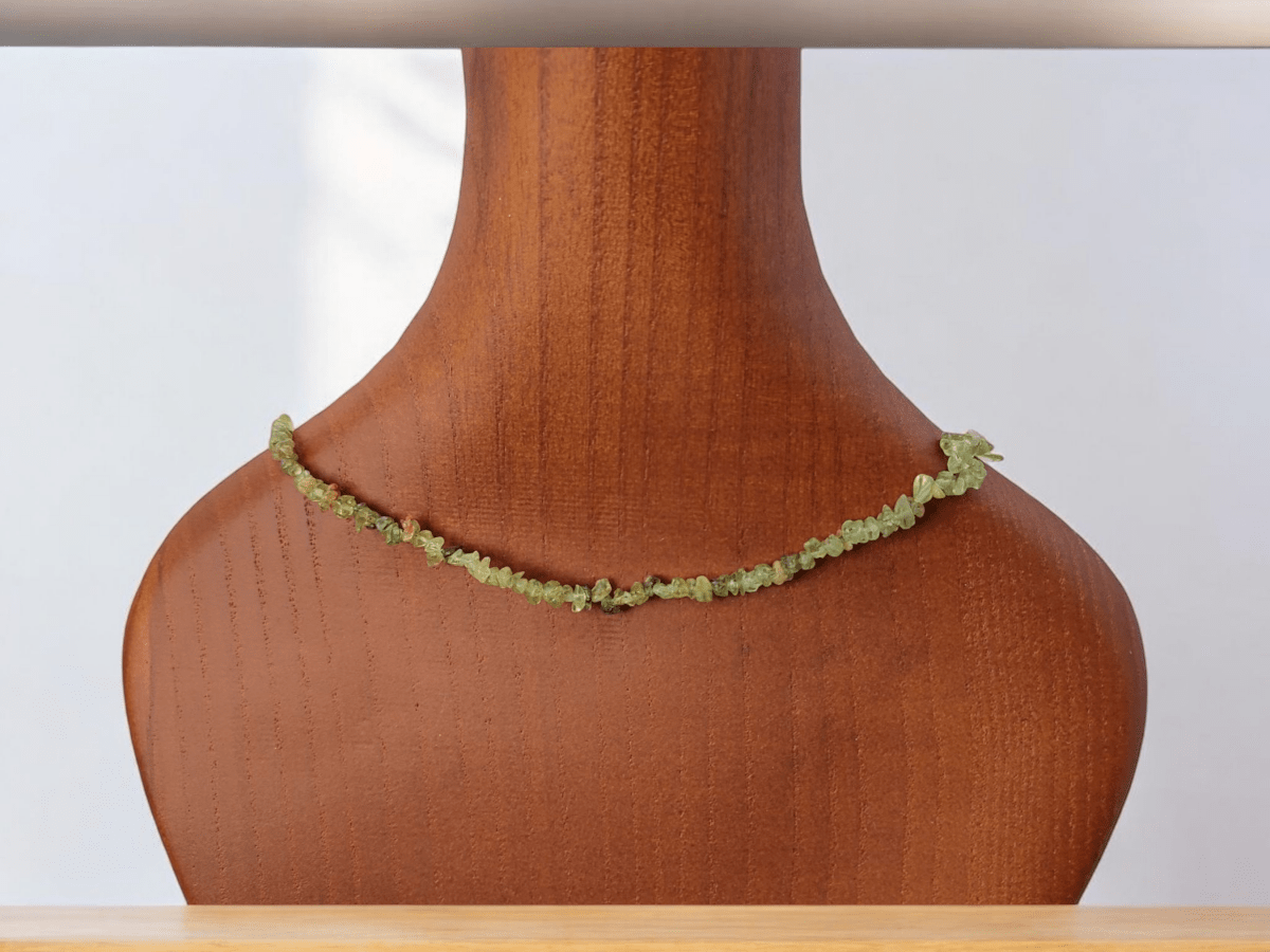 A peridot beaded choker on a wooden bust Main image