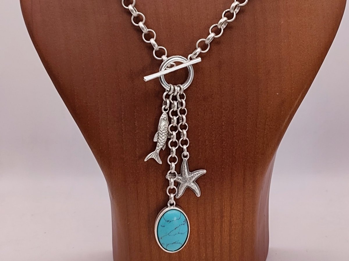Sky Turquoise Charm Lariat Necklace with fish, starfish and turquoise charm- on a wooden bust
