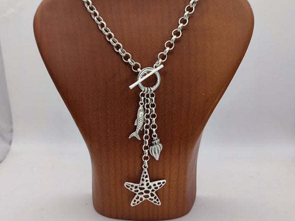 Starfish and fish Charm Y Necklace on a wooden bust