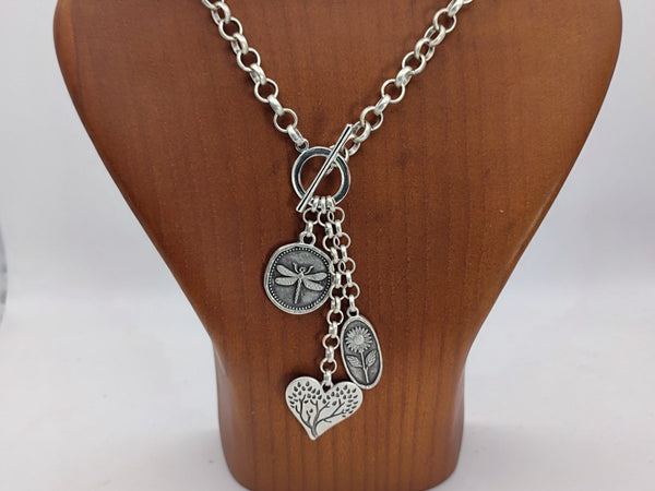 Nature inspired Charm Lariat Necklace with dragonfly, flower and tree charms - on a wooden bust