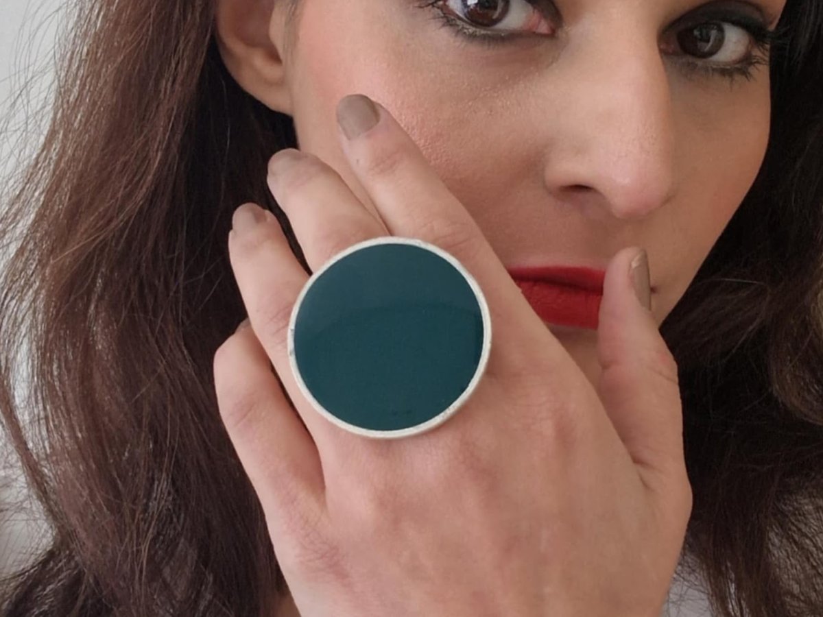 A model wearing a dark green ring