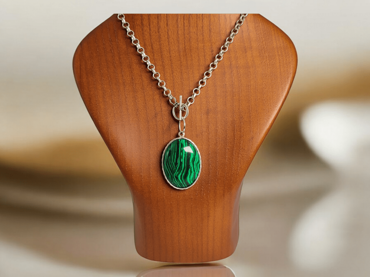 A Malachite pendant on a wooden bust 
