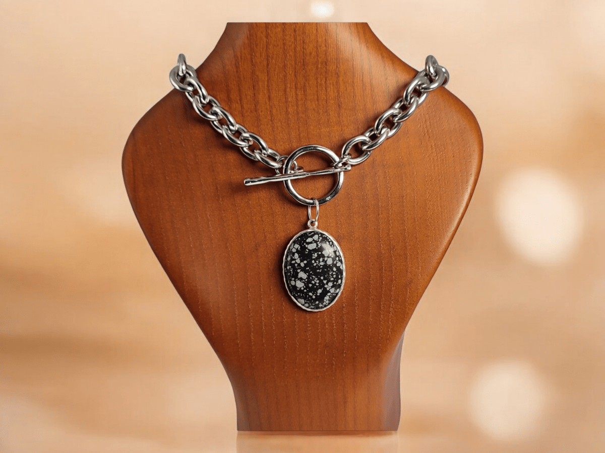 Snowflake Obsidian pendant on a chunky chain displayed on a wooden bust Main image