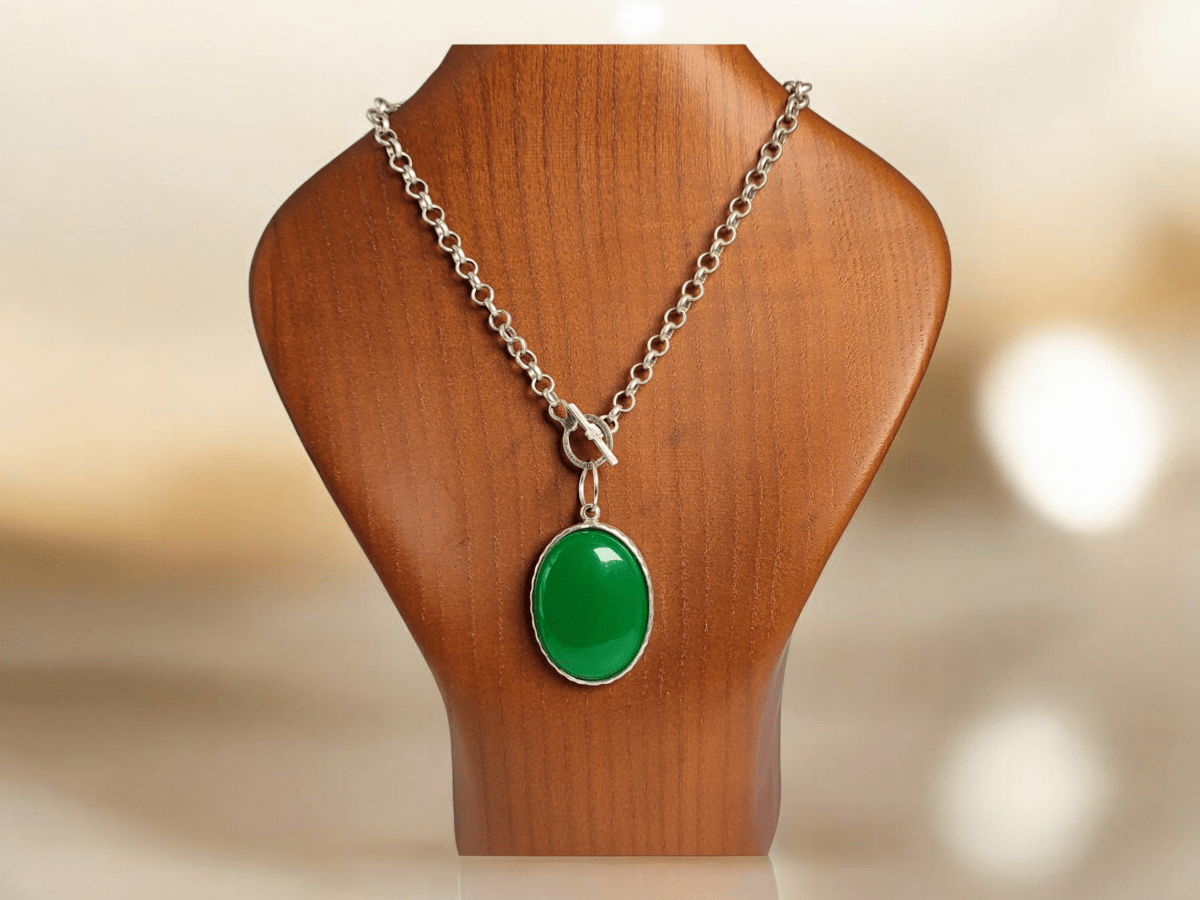 A green Jade pendant on a wooden bust Main image