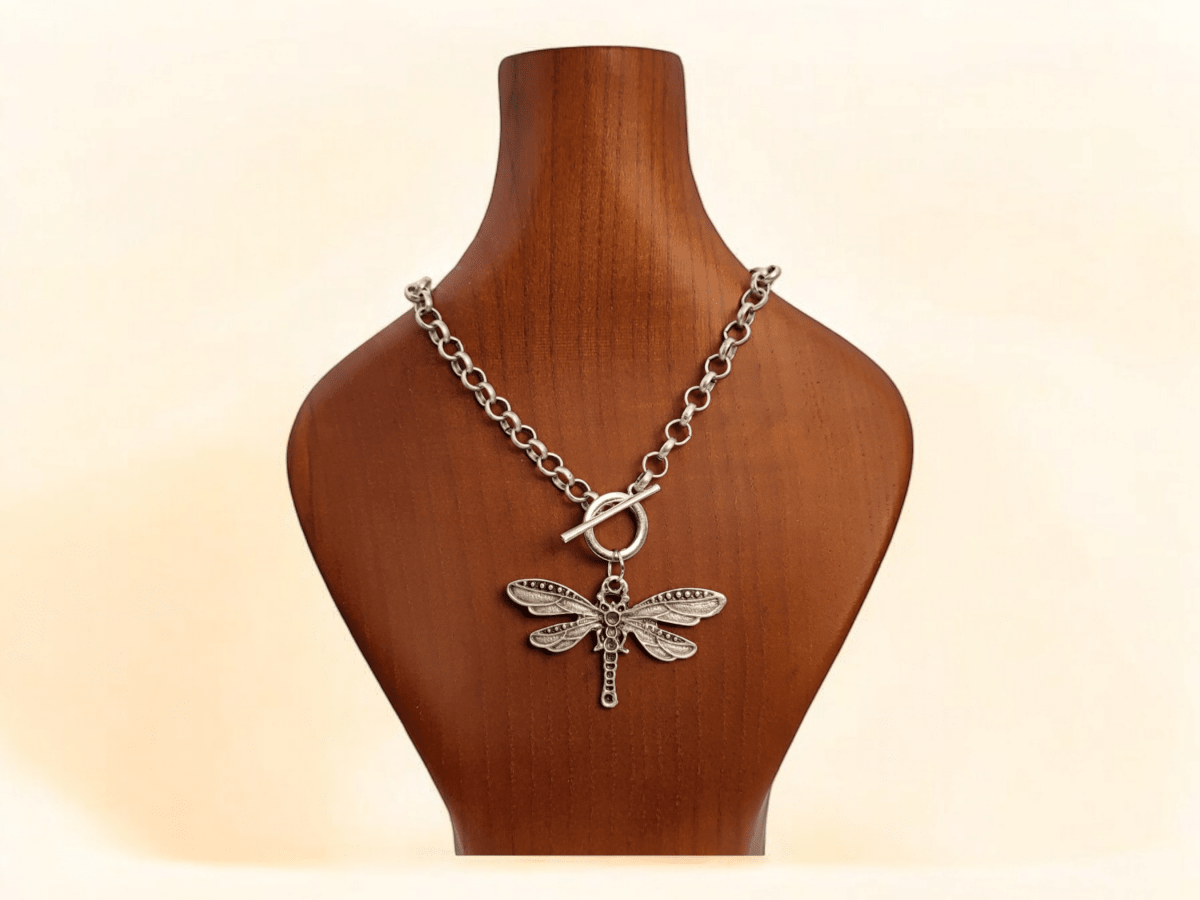 Dragonfly pendant on a silver chain on a wooden bust Main image