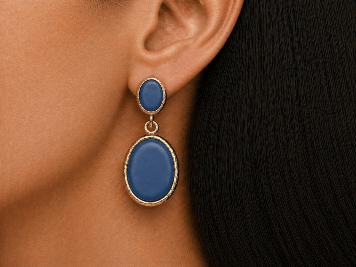 A model wearing some oval royal blue dangle drop earrings
