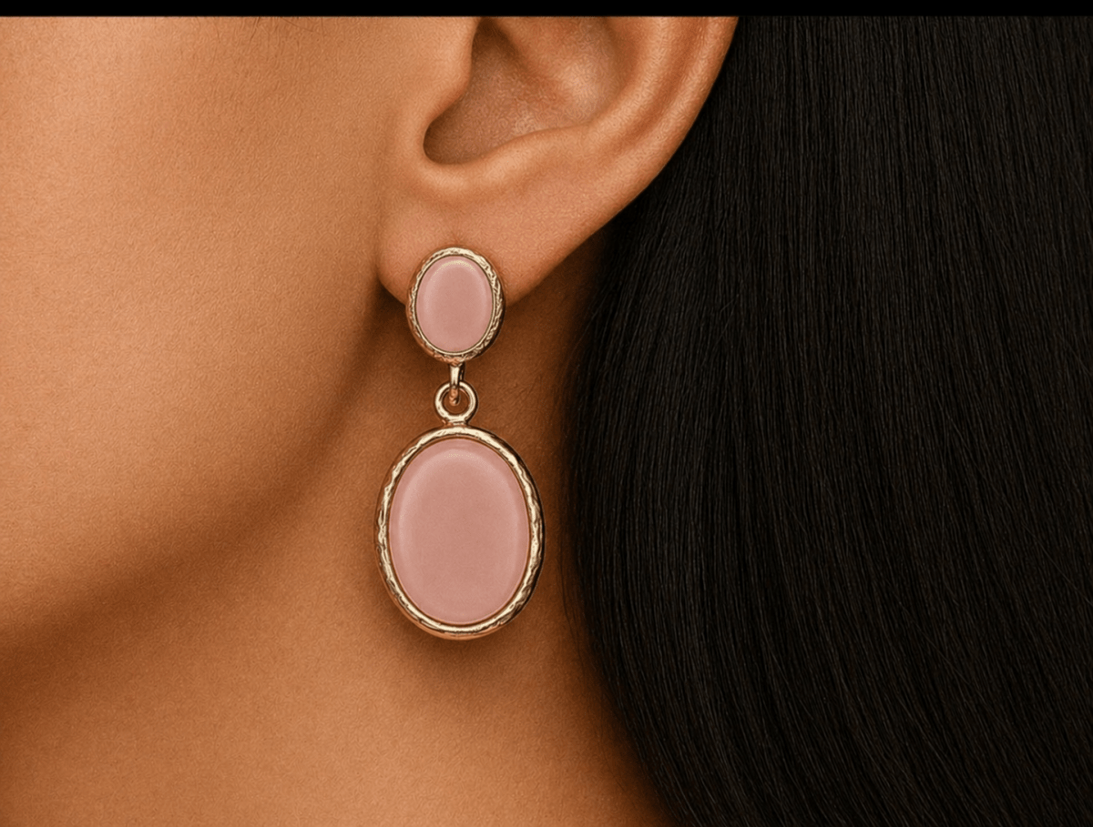 A model wearing some oval salmon pink dangle drop earrings