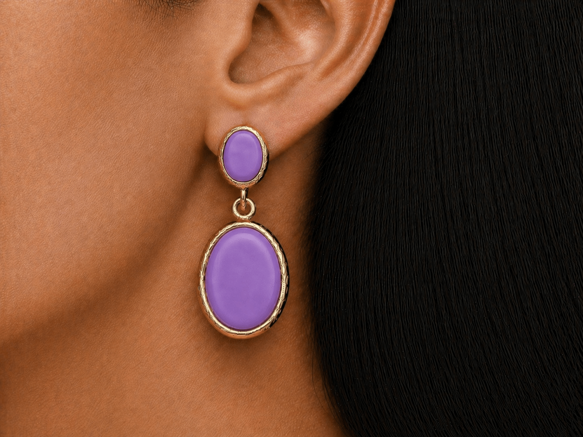 A model wearing some oval violet dangle drop earrings