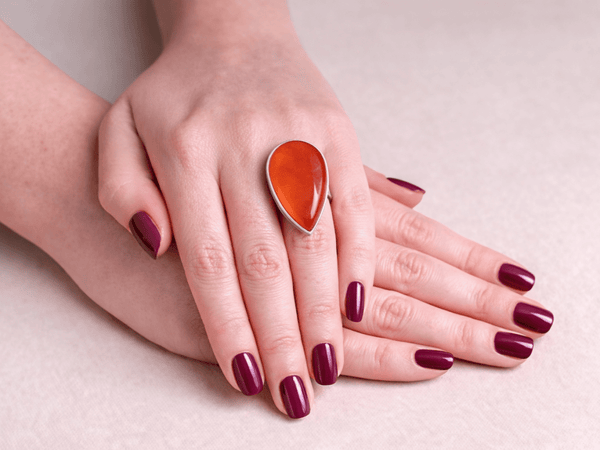 A bold carnelian ring with rich, fiery orange tones that instantly stand out.Being worn on a models hand