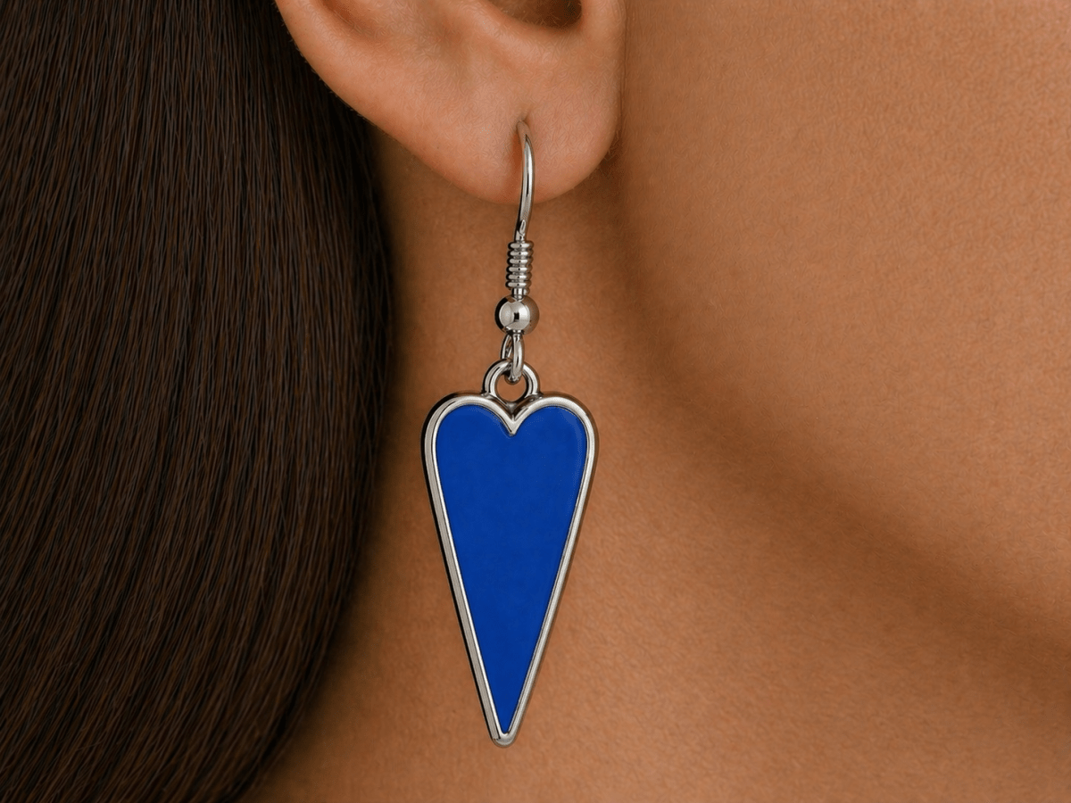 A model wearing some bright blue heart shaped earrings