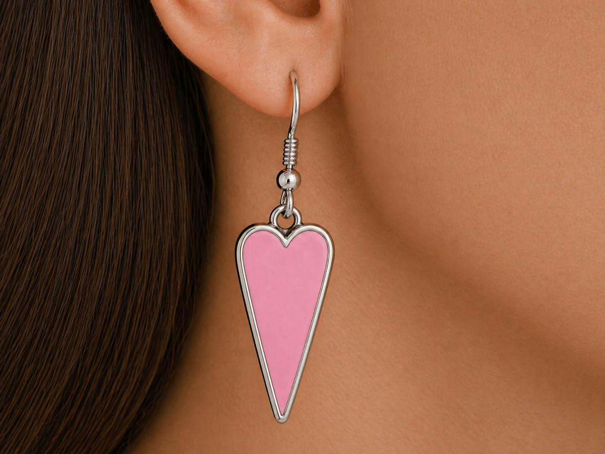 A model wearing some pale pink heart shaped earrings