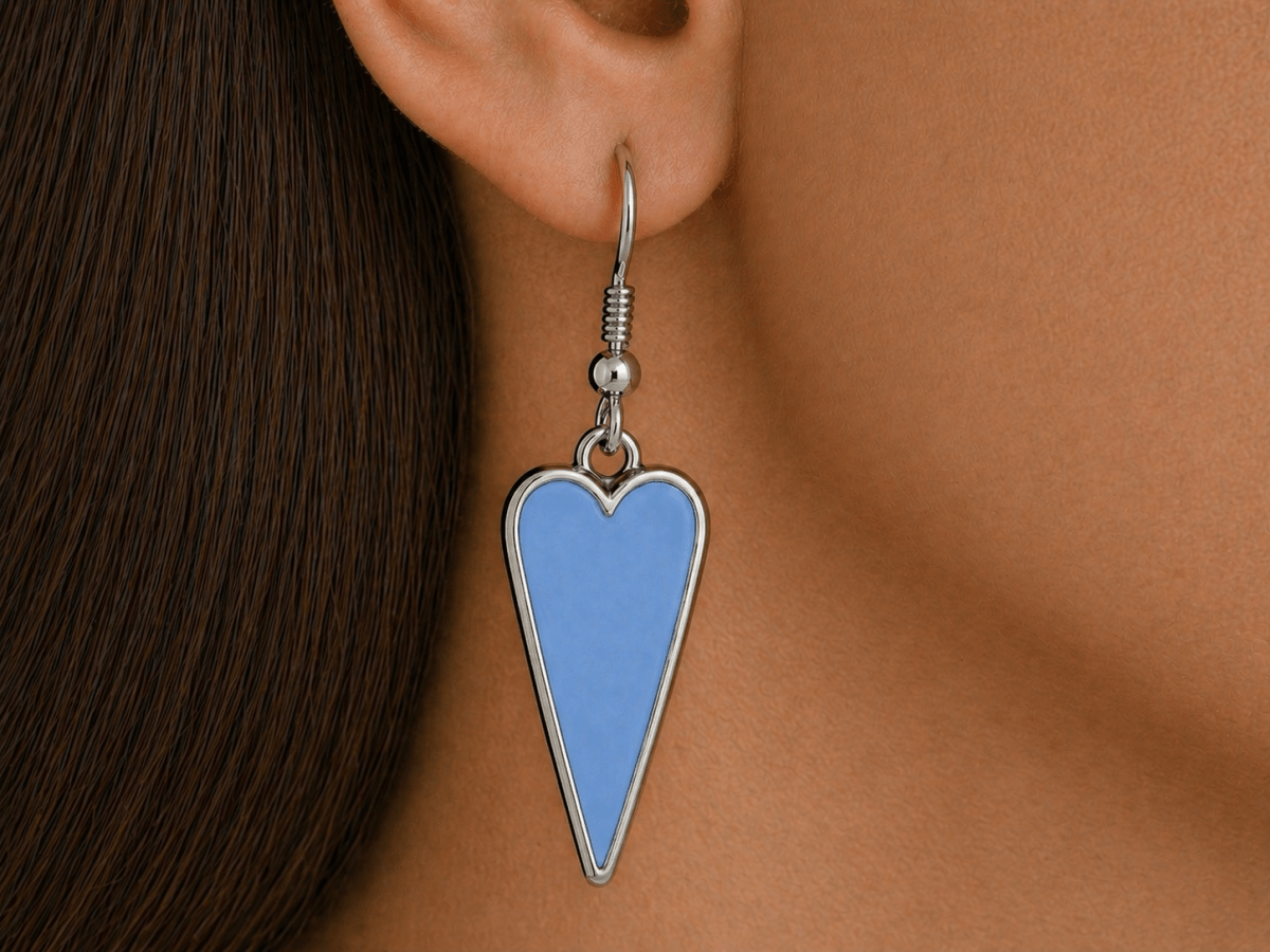 A model wearing some pale blue heart shaped earrings