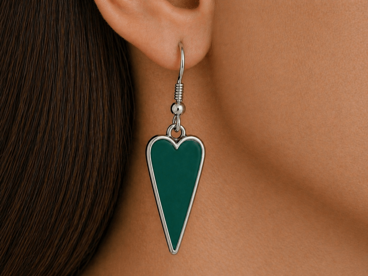 A model wearing some dark green heart shaped earrings
