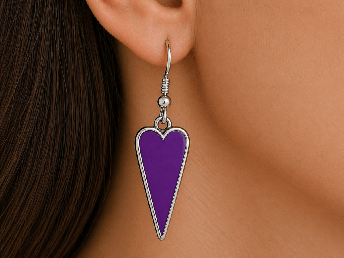 A model wearing some purple heart shaped earrings