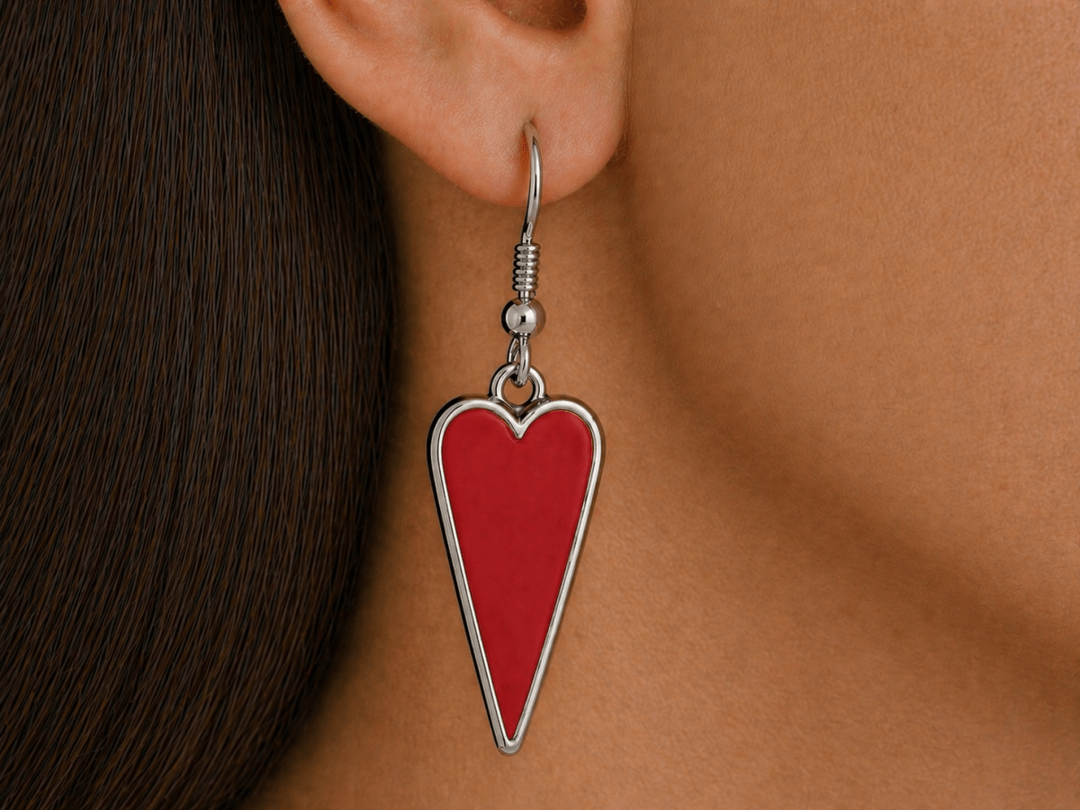 A model wearing some red heart shaped earrings
