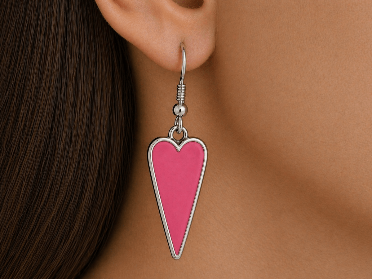 A model wearing some deep pink heart shaped earrings