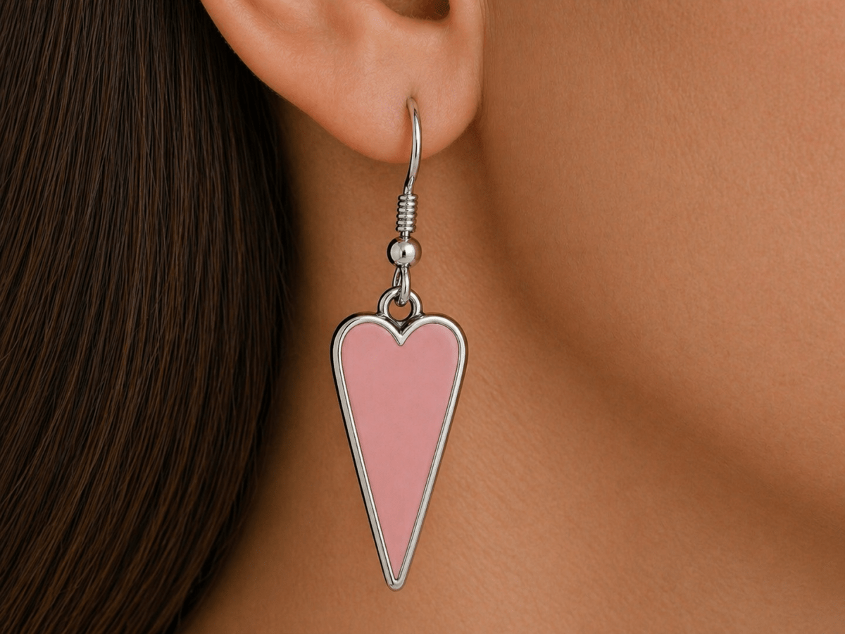 A model wearing some salmon pink heart shaped earrings