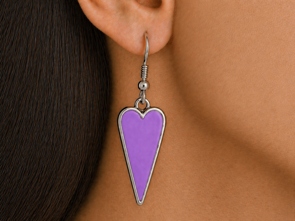 A model wearing some violet heart shaped earrings
