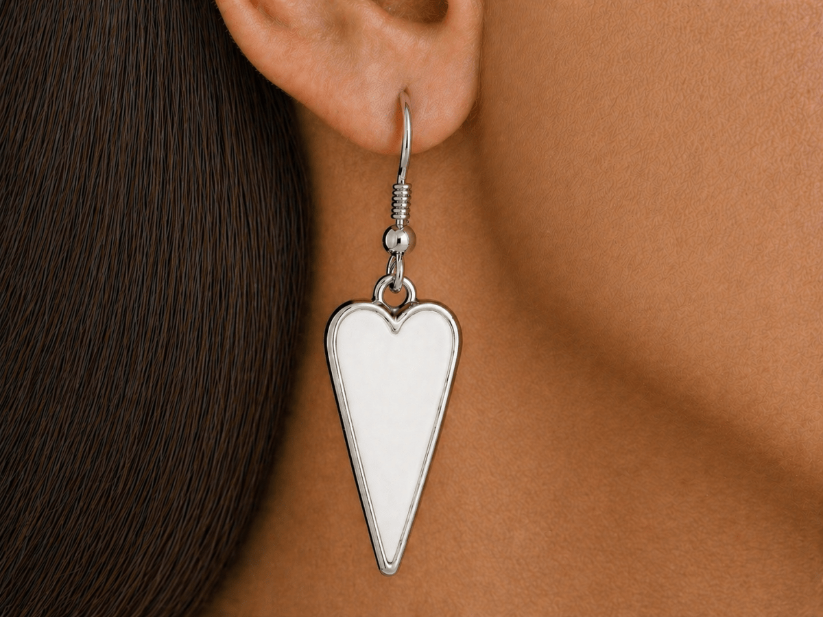 A model wearing some white heart shaped earrings
