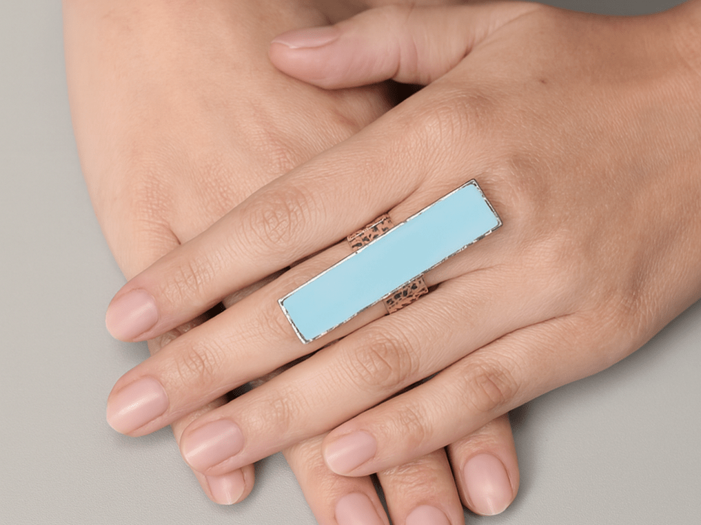 Brielle long rectangular pale blue ring worn on a models hand - Corky & Stoner Main image