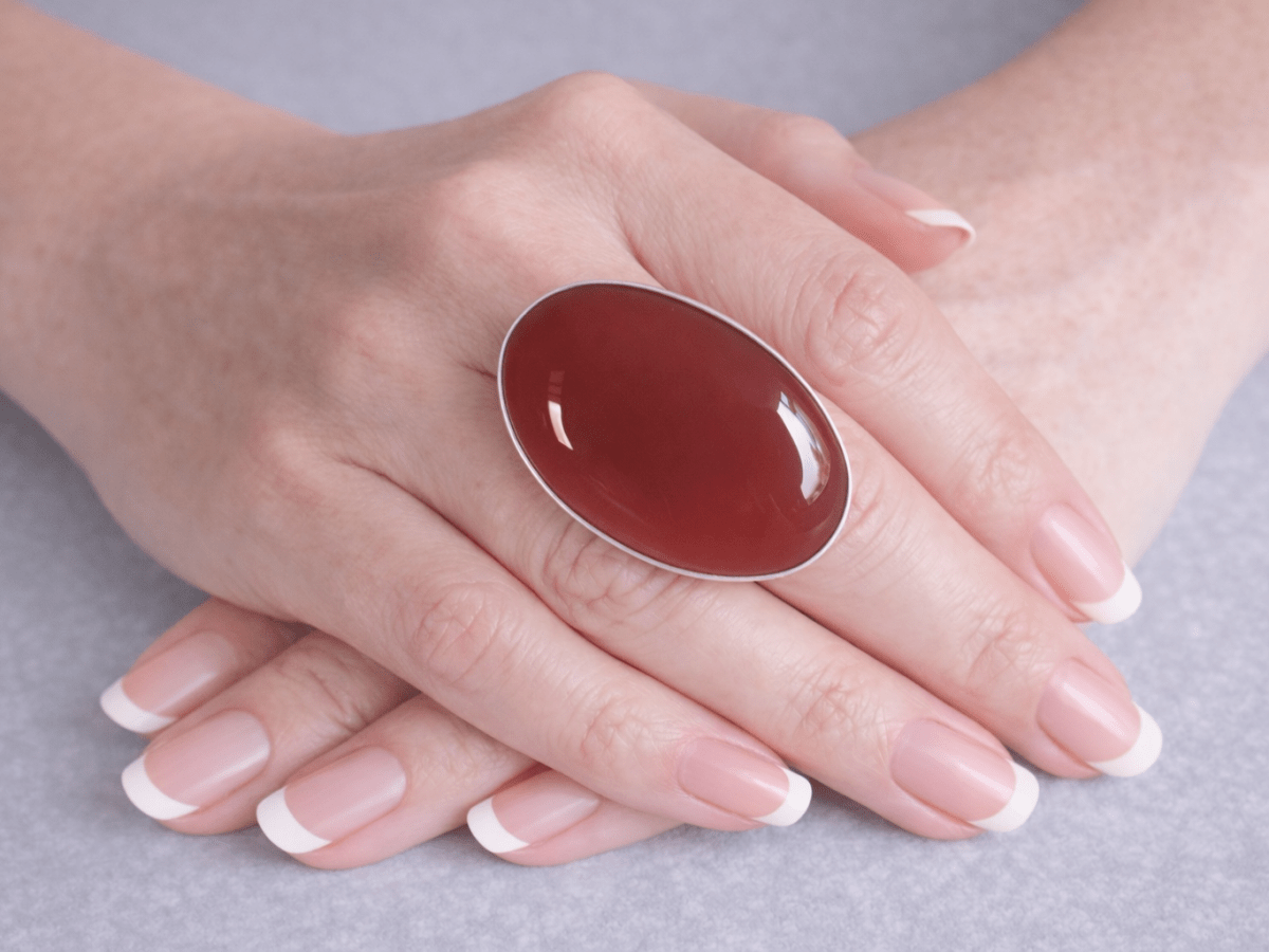 A bold silver carnelian ring from Corky and Stoner with deep, warm red-orange tones and a smooth, polished finish that gives it a rich, glowing look. Main image