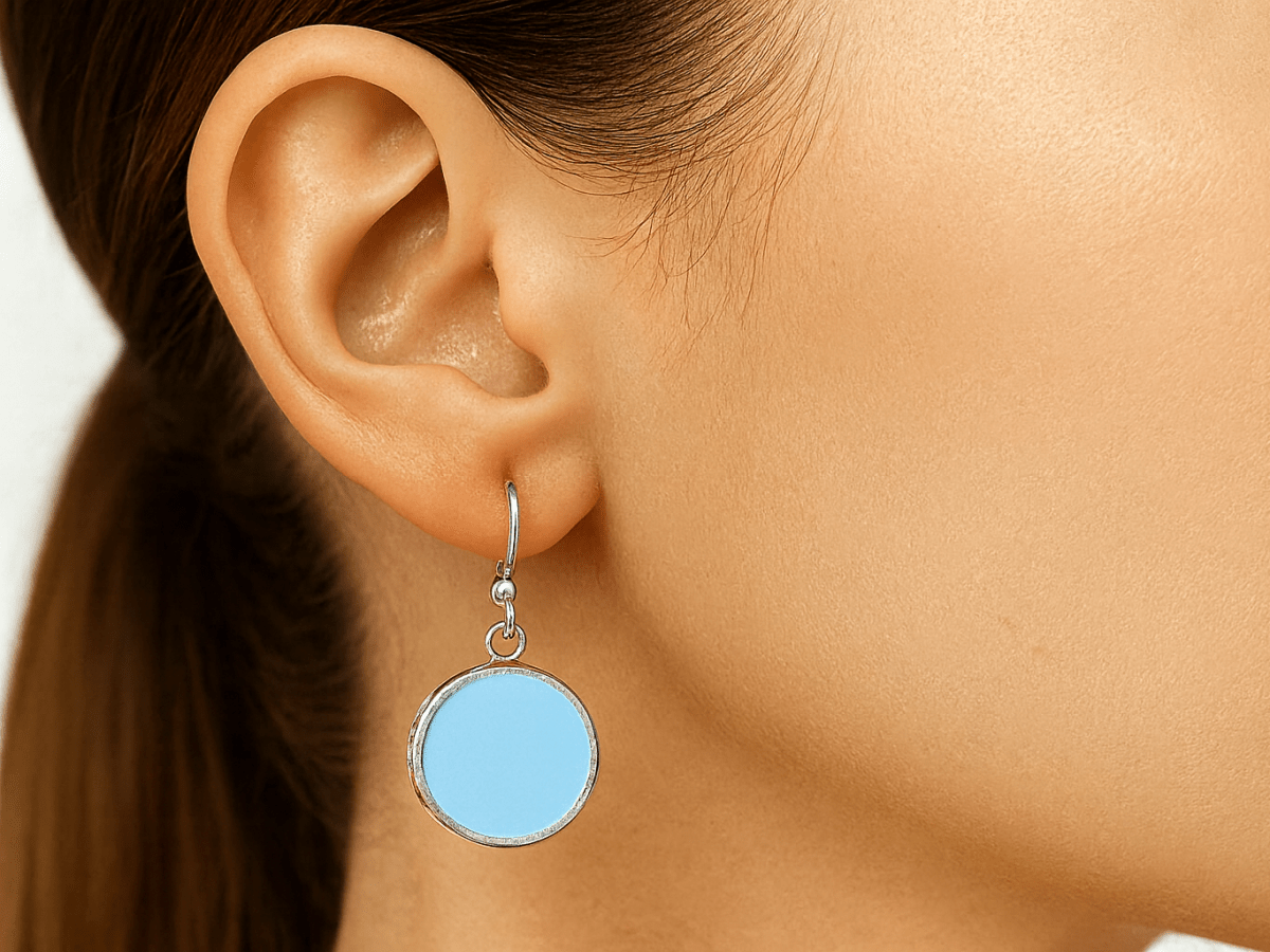 Brianna pale blue round earrings worn by a model - Corky & Stoner Main image