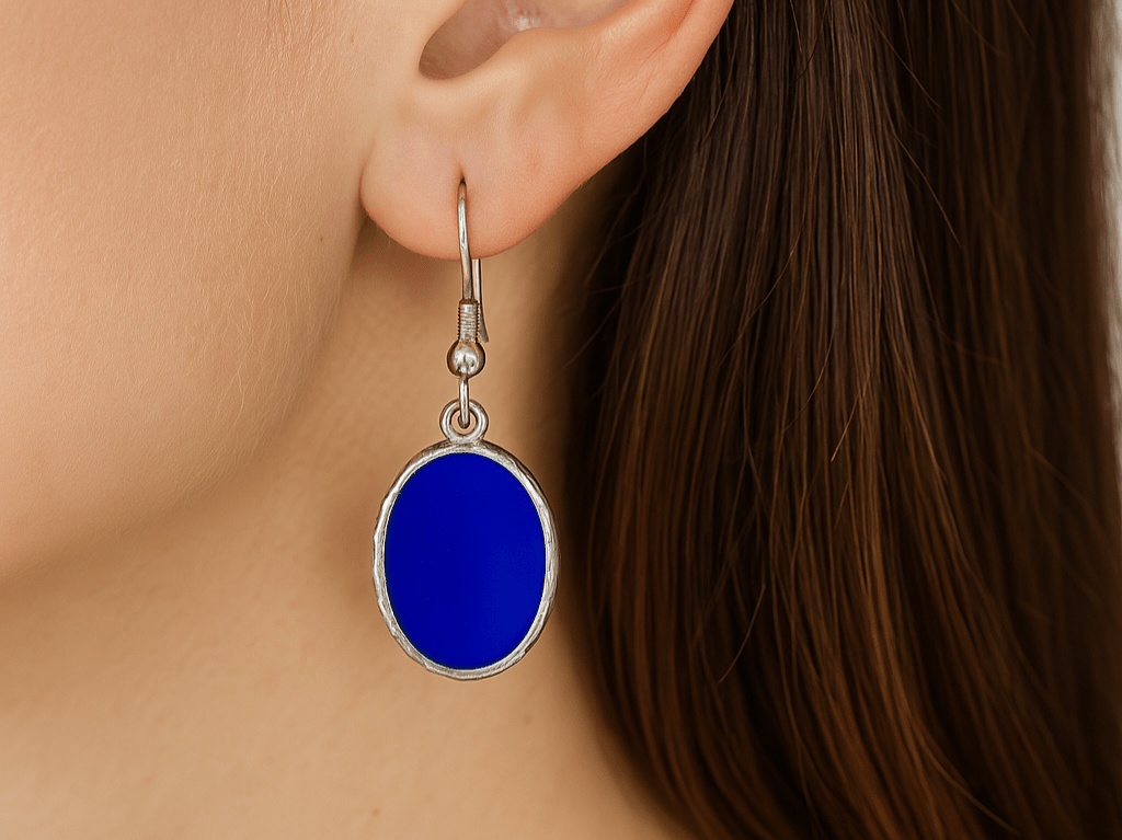 A model wearing some blue oval dangle drop earrings