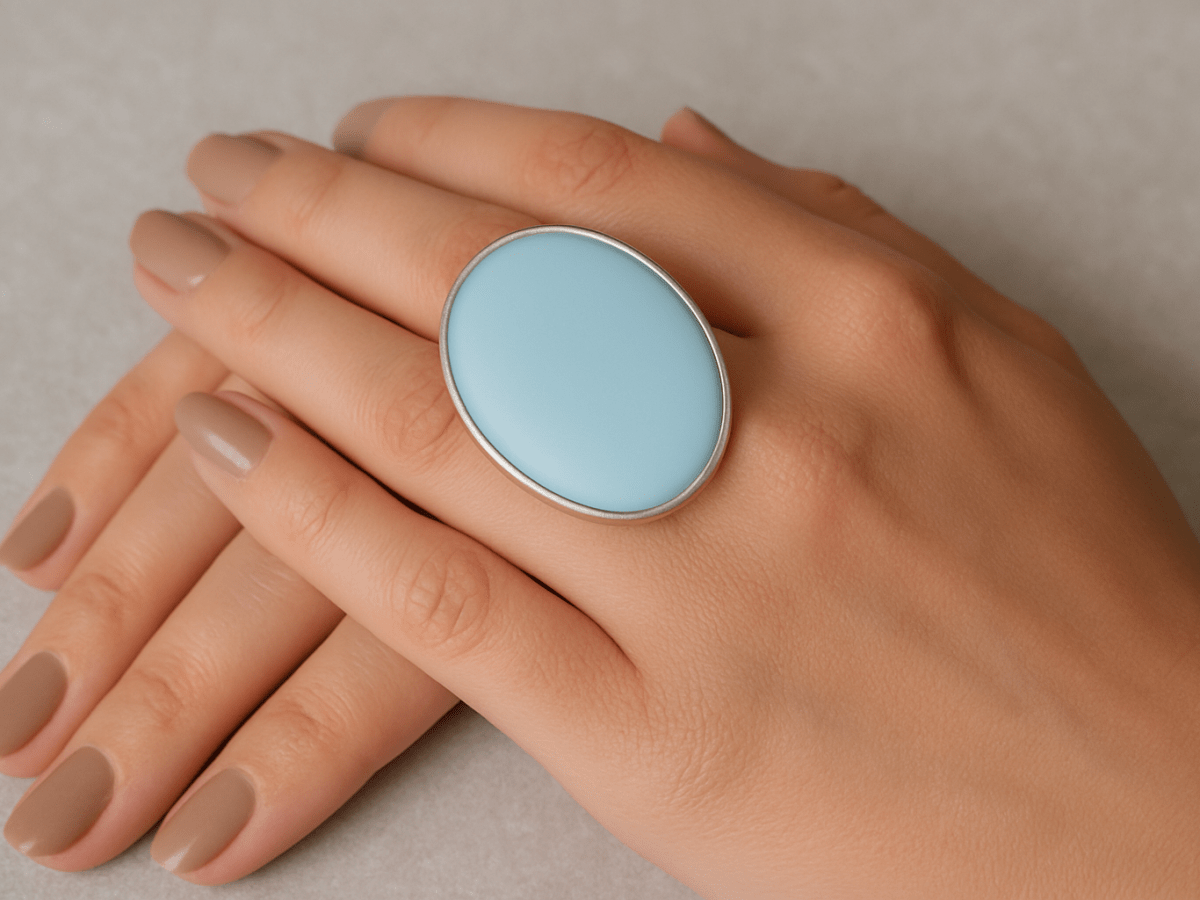 Sloane pastel blue oval ring being worn on a models hand - Corky & Stoner Main image