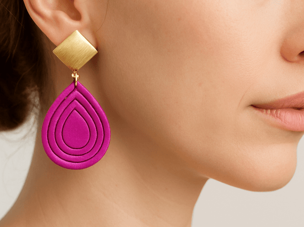 lightweight cerise pink teardrop earrings worn by a model
