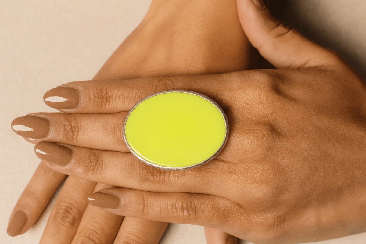 A models hands wearing a neon yellow oval ring Main image