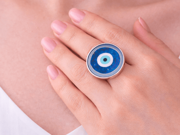 evil eye adjustable ring being worn on a models hand 