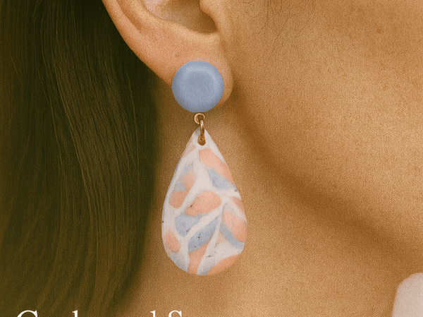 a model wearing some pink and blue teardrop earrings