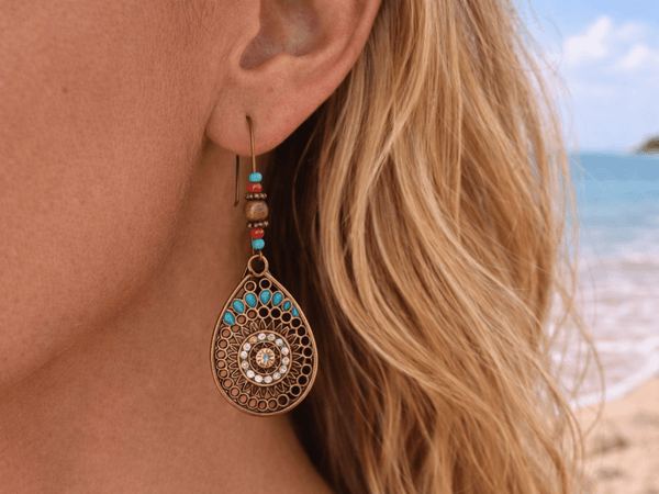 Alondra boho bronze and turquoise drop earrings being worn by a model - Corky & Stoner