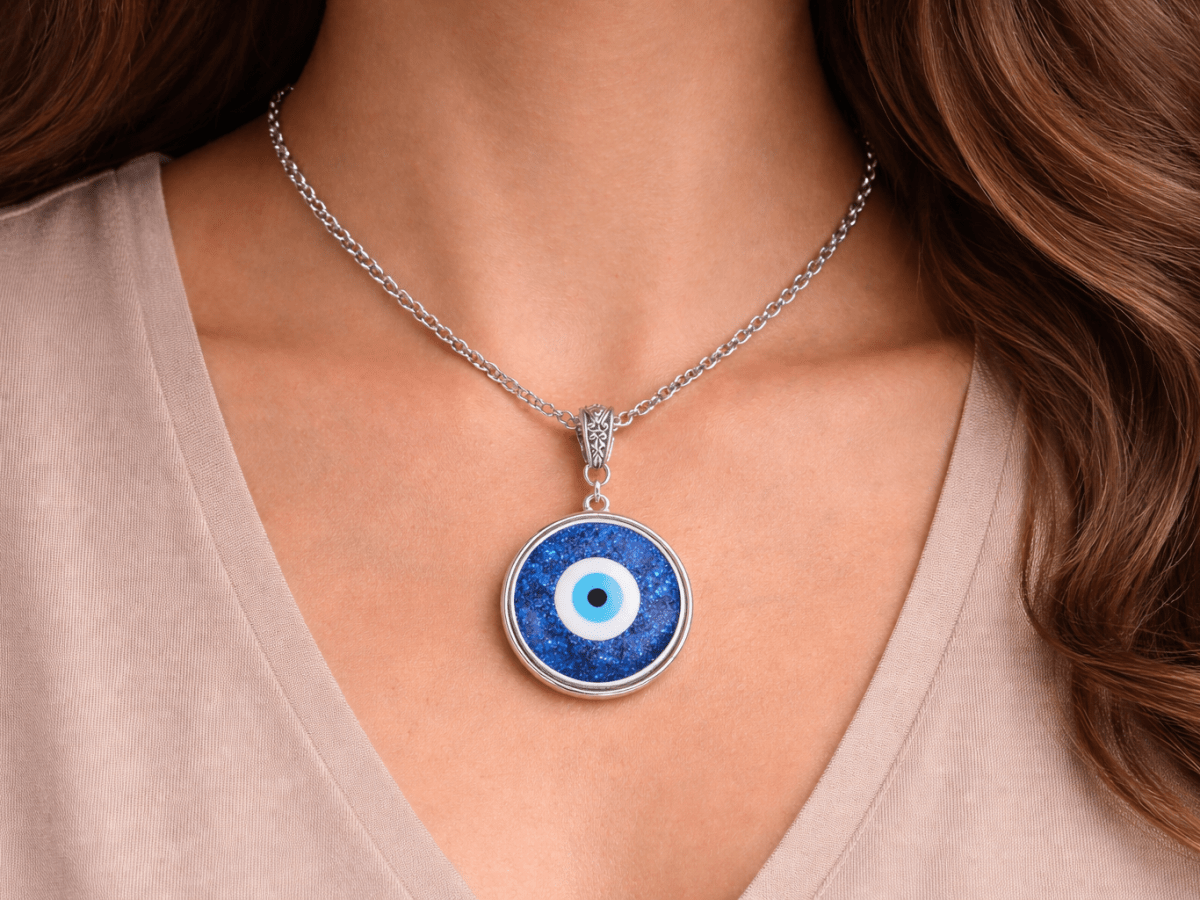 evil eye pendant necklace being worn by a model  in a white top Main image