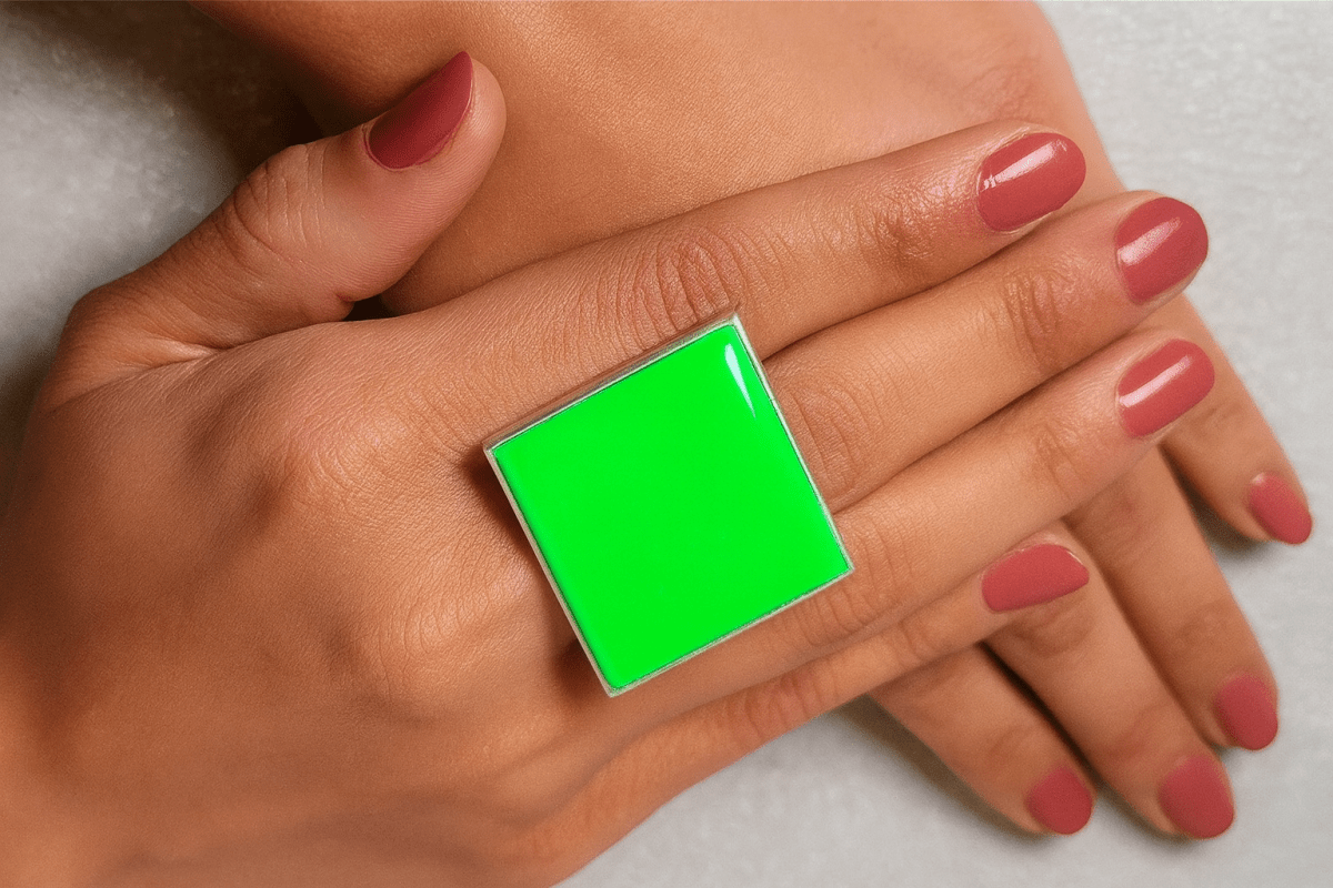 models hand wearing a bright neon green square ring Main image