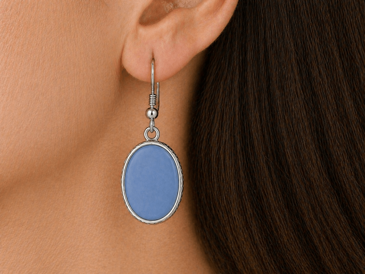 A model wearing some blue oval dangle drop earrings