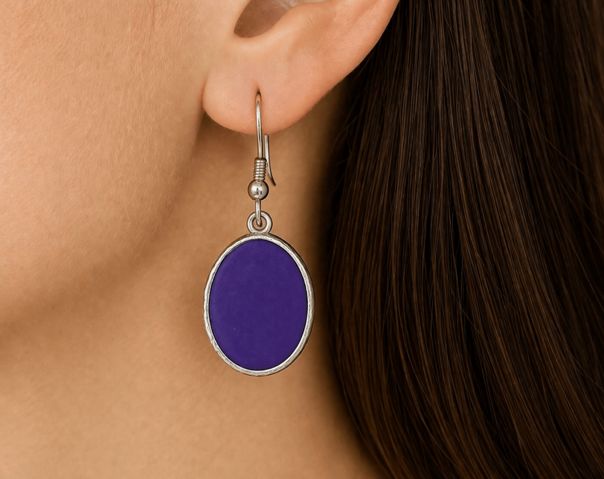 A model wearing some purple oval dangle drop earrings