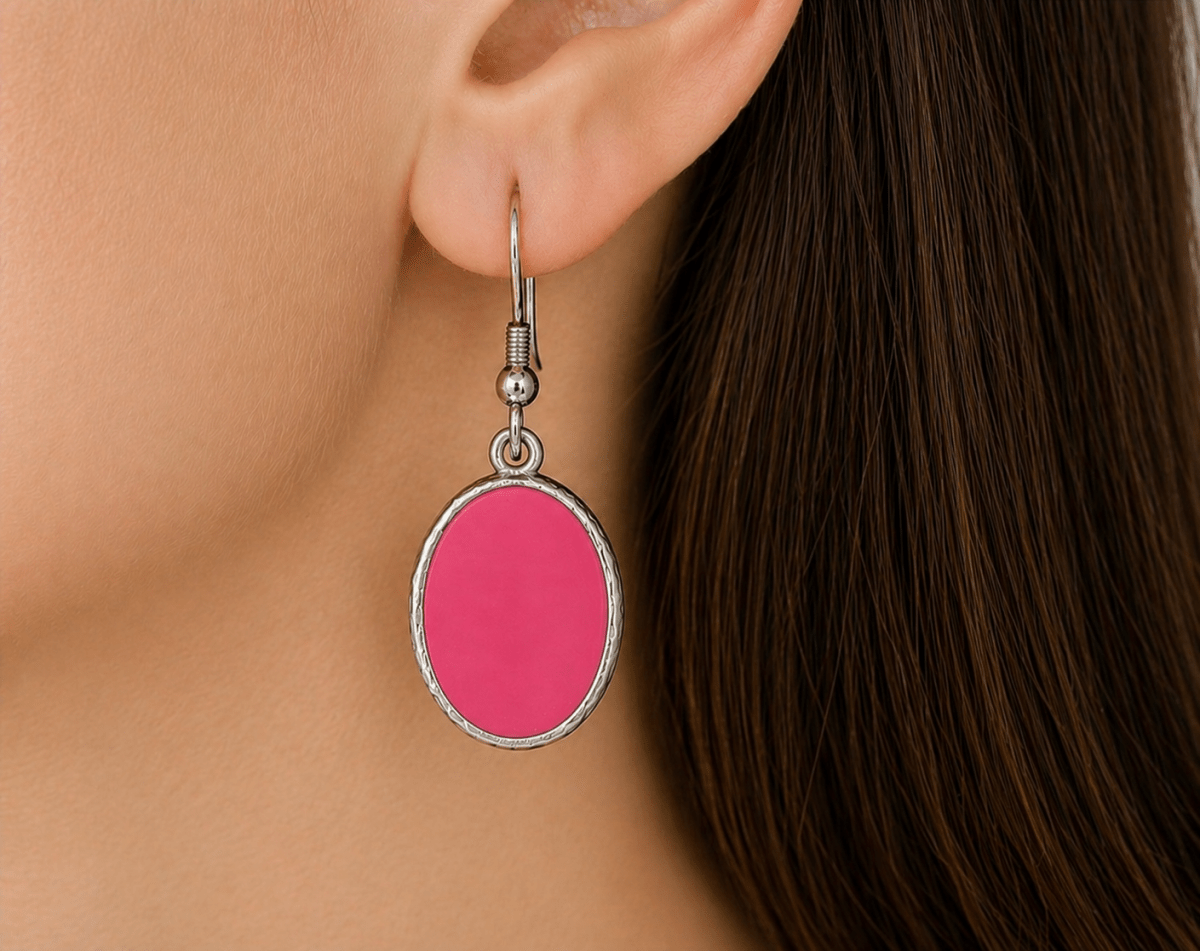 A model wearing some deep pink oval dangle drop earrings